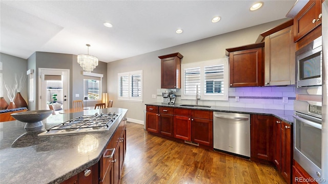 6945 N Fargo Trl, Littleton, CO 80125 - kitchen featuring appliances with stainless steel finishes, dark wood-type flooring, a chandelier, recessed lighting, and pendant lighting