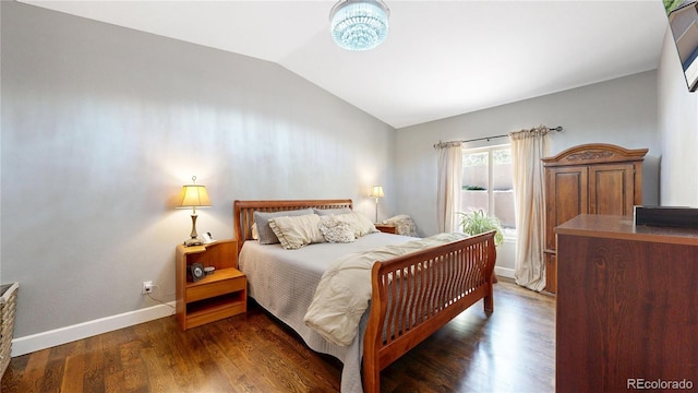 6945 N Fargo Trl, Littleton, CO 80125 - bedroom featuring vaulted ceiling, wood finished floors, and baseboards
