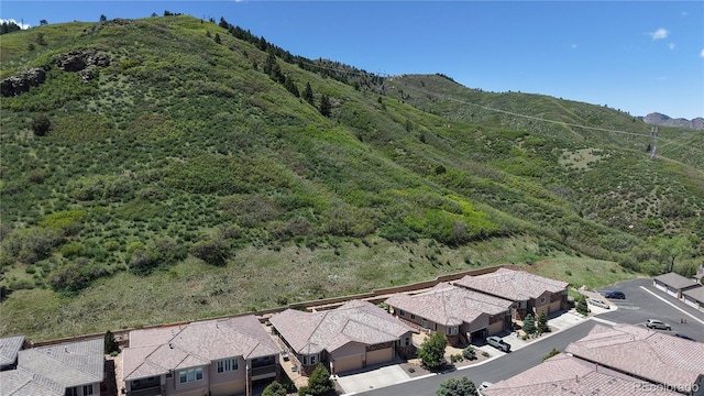 6945 N Fargo Trl, Littleton, CO 80125 - aerial view of residential area with a mountain backdrop and a heavily wooded area