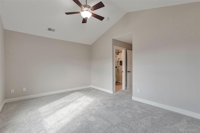 carpeted spare room featuring lofted ceiling and ceiling fan