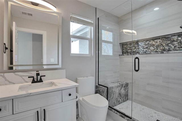 bathroom with vanity, toilet, and walk in shower