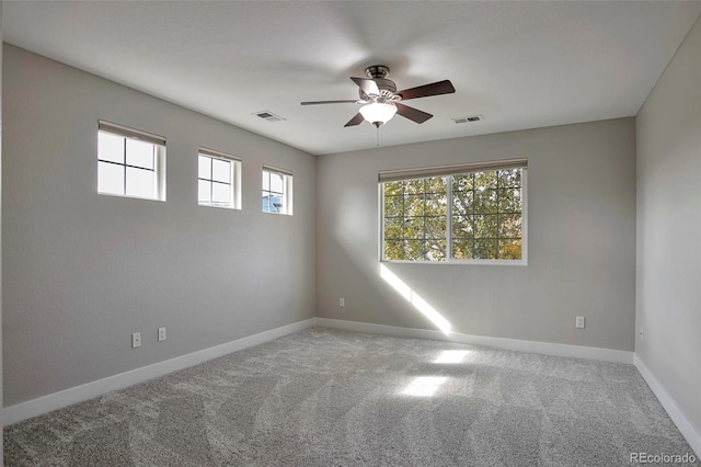 carpeted spare room featuring ceiling fan