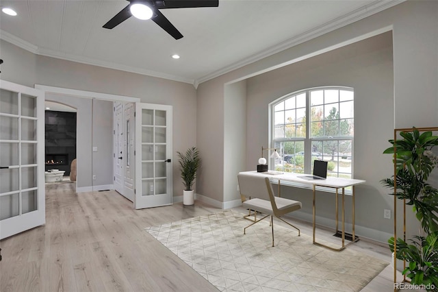 office with french doors, crown molding, light wood-type flooring, and ceiling fan