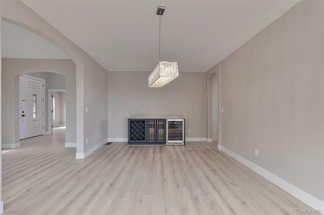 interior space featuring wine cooler and light hardwood / wood-style floors