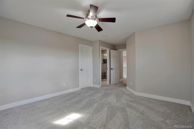 unfurnished bedroom featuring a closet, ceiling fan, and light colored carpet