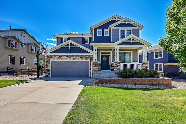 craftsman-style house featuring a front lawn, covered porch, and a garage