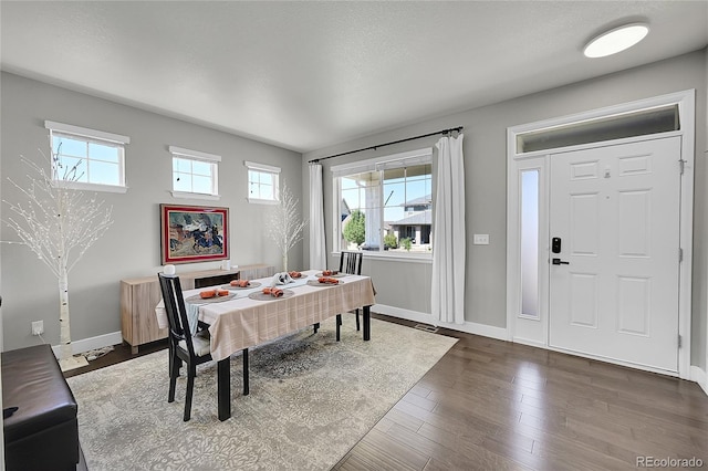 dining space featuring dark hardwood / wood-style flooring