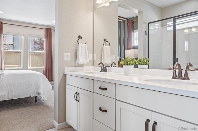 bathroom featuring a shower with door and vanity