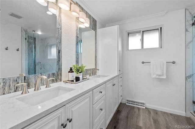 6243 S Elati St, Littleton, CO 80120 - full bathroom with a marble finish shower, double vanity, and wood finished floors