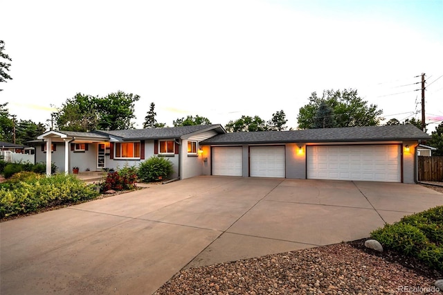 6243 S Elati St, Littleton, CO 80120 - ranch-style house featuring concrete driveway, stucco siding, and a garage