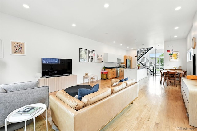 4129 Zenobia St, Denver, CO 80212 - living area featuring light wood-type flooring, recessed lighting, and stairway