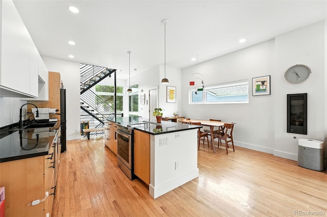 4129 Zenobia St, Denver, CO 80212 - kitchen with stainless steel range with electric cooktop, dark countertops, plenty of natural light, and recessed lighting