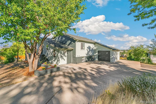 5385 W 51st Ave, Denver, CO 80212 - view of front facade featuring concrete driveway, stairway, and stucco siding