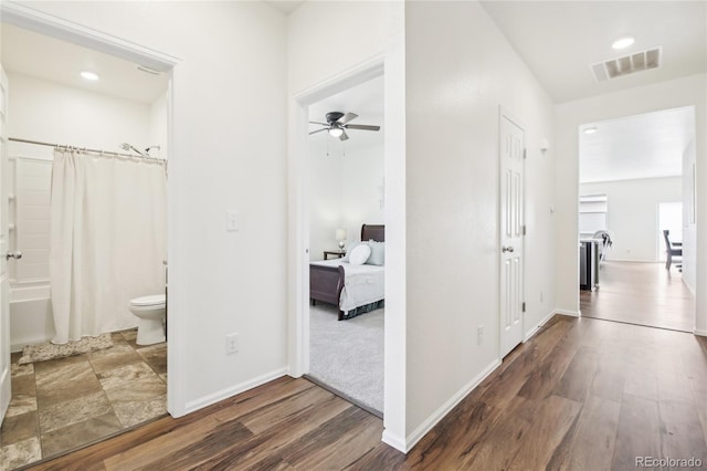 corridor featuring recessed lighting, baseboards, visible vents, and wood finished floors