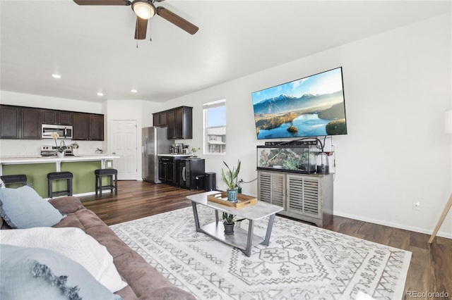 living area with dark wood-style flooring, baseboards, a ceiling fan, and recessed lighting