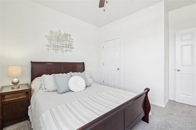 carpeted bedroom featuring baseboards and a ceiling fan