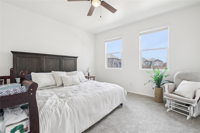 bedroom with ceiling fan, light carpet, and baseboards