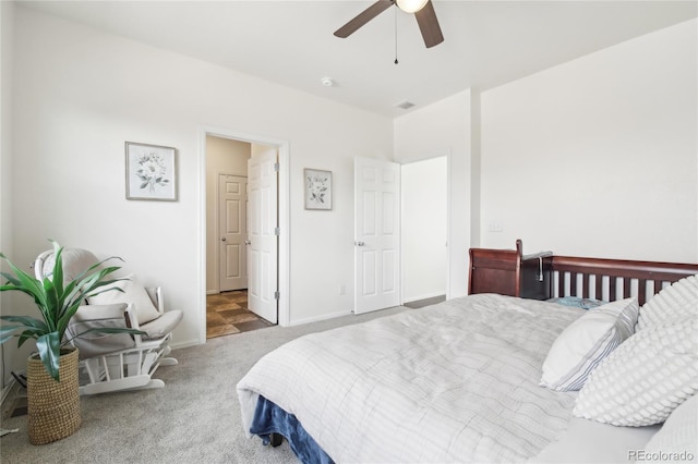 bedroom with ceiling fan, carpet flooring, and baseboards