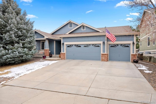 craftsman inspired home with a garage and covered porch