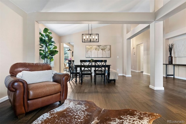 dining space with vaulted ceiling, dark wood-type flooring, and an inviting chandelier