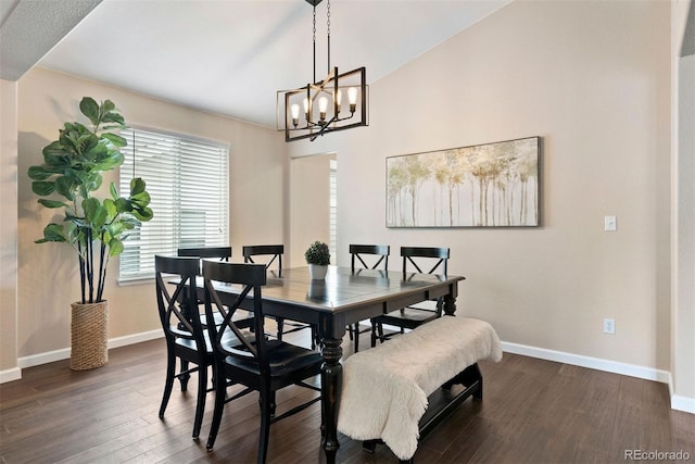 dining space featuring dark wood-type flooring and a chandelier