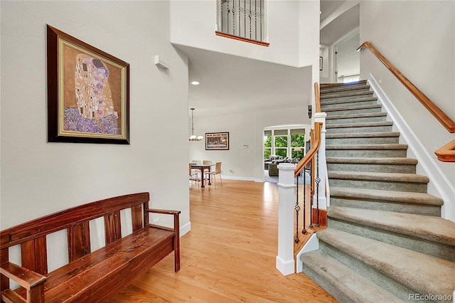 24965 E Roxbury Pl, Aurora, CO 80016 - staircase featuring wood finished floors and a towering ceiling