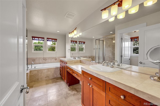 24965 E Roxbury Pl, Aurora, CO 80016 - bathroom with a bath, vanity, a shower stall, and tile patterned floors