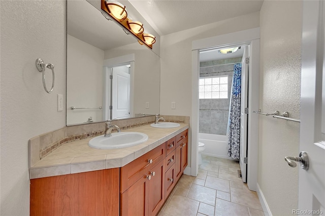 24965 E Roxbury Pl, Aurora, CO 80016 - full bath featuring double vanity, tile patterned flooring, and shower / tub combo with curtain