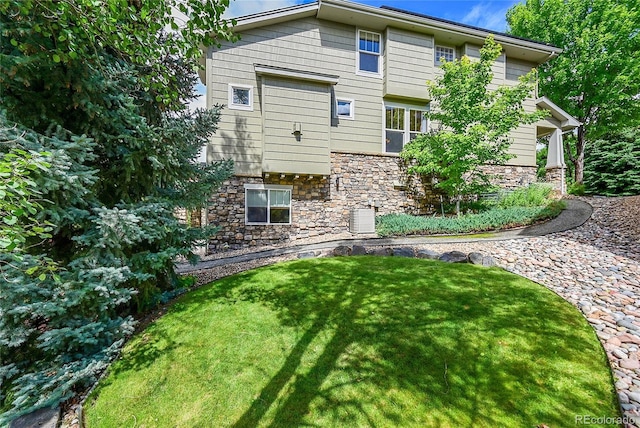 24965 E Roxbury Pl, Aurora, CO 80016 - back of house with stone siding and a yard