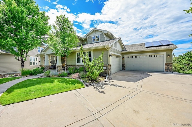 24965 E Roxbury Pl, Aurora, CO 80016 - craftsman house featuring an attached garage, stone siding, a front lawn, roof mounted solar panels, and driveway