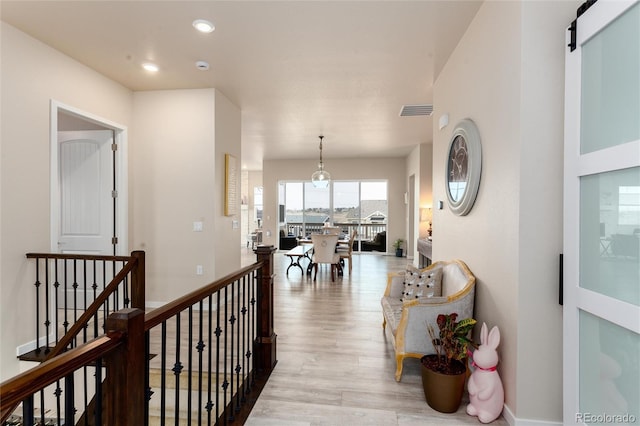 6657 S Kline Way, Littleton, CO 80127 - corridor featuring wood finished floors, recessed lighting, and a barn door