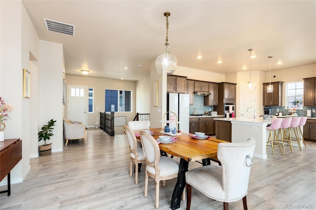 6657 S Kline Way, Littleton, CO 80127 - dining space featuring light wood-style floors, plenty of natural light, baseboards, and recessed lighting