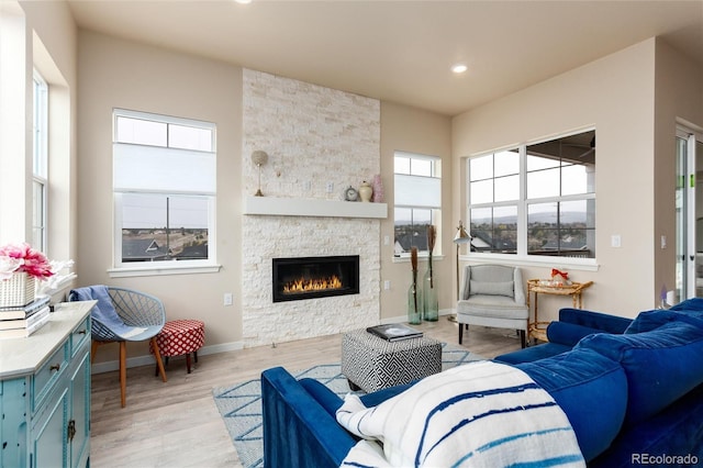 6657 S Kline Way, Littleton, CO 80127 - living area with a fireplace, light wood-style floors, recessed lighting, and baseboards