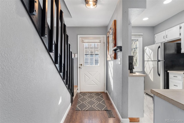 entryway with wood-type flooring