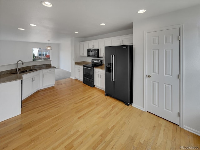 16453 E Phillips Dr, Englewood, CO 80112 - kitchen featuring black appliances, white cabinetry, light wood-style flooring, recessed lighting, and decorative light fixtures
