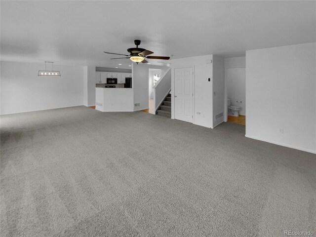 16453 E Phillips Dr, Englewood, CO 80112 - unfurnished living room with carpet floors, ceiling fan, and stairs