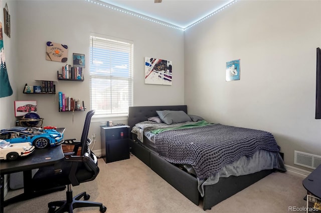 carpeted bedroom with visible vents and baseboards