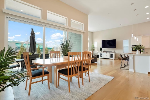 dining space with light wood-style flooring and recessed lighting