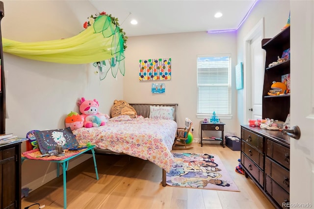 bedroom featuring baseboards, light wood-type flooring, and recessed lighting