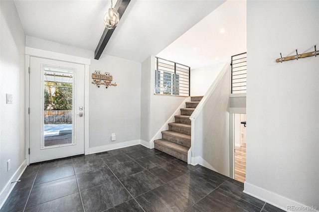 entrance foyer featuring beamed ceiling