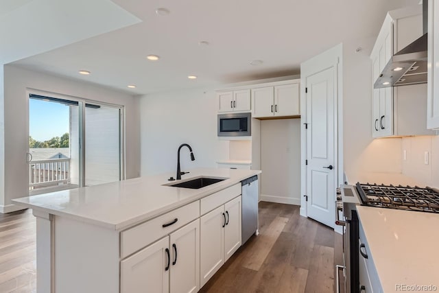 kitchen featuring white cabinetry, sink, dark hardwood / wood-style floors, an island with sink, and appliances with stainless steel finishes