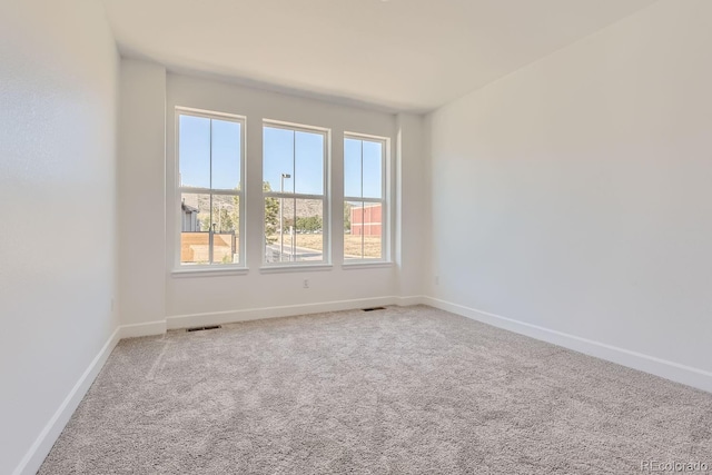 unfurnished room featuring carpet flooring