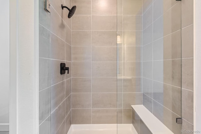 bathroom with tiled shower