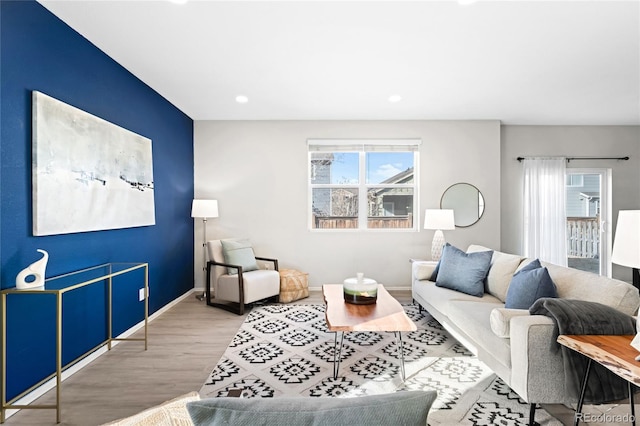 living area with recessed lighting, baseboards, and wood finished floors