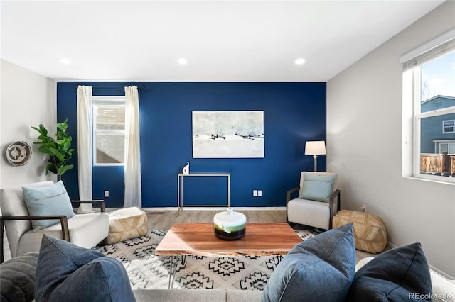 living area with recessed lighting, baseboards, and wood finished floors