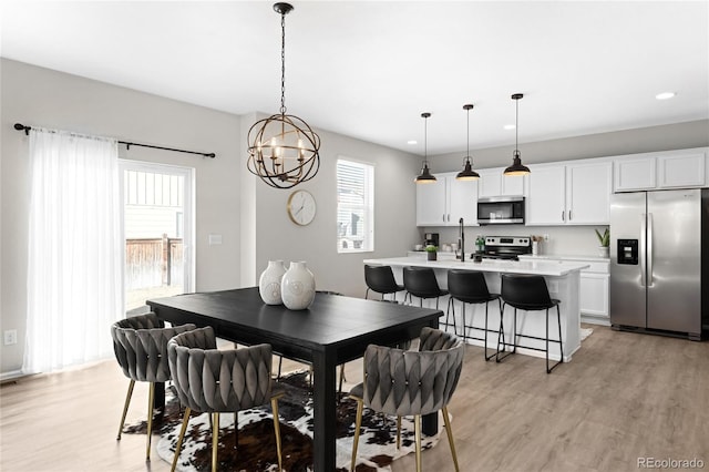 dining space featuring recessed lighting and light wood finished floors