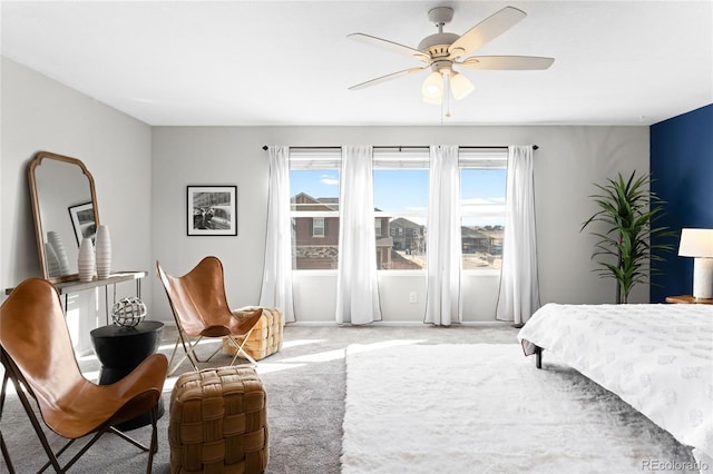 bedroom featuring light carpet and ceiling fan