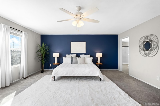 carpeted bedroom with baseboards and ceiling fan