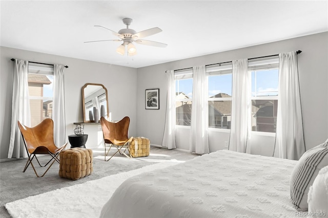 bedroom featuring multiple windows, carpet, and ceiling fan