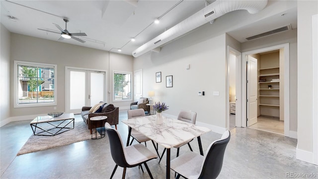 dining area with baseboards, french doors, visible vents, and finished concrete floors